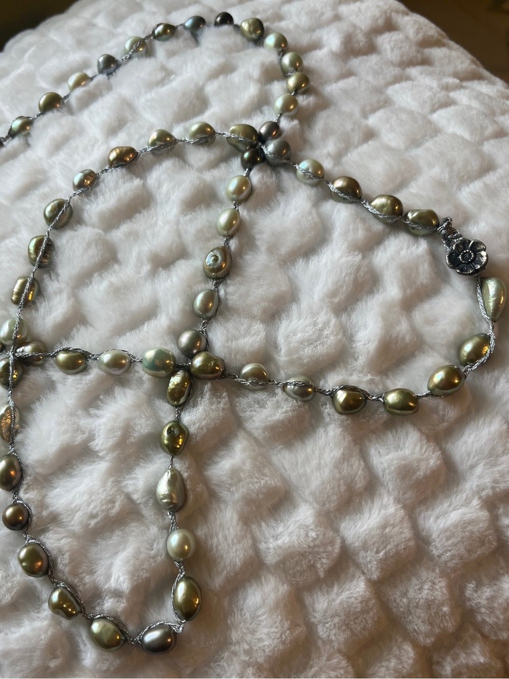Iridescent green freshwater baroque pearl necklace strung on silver-colored cord